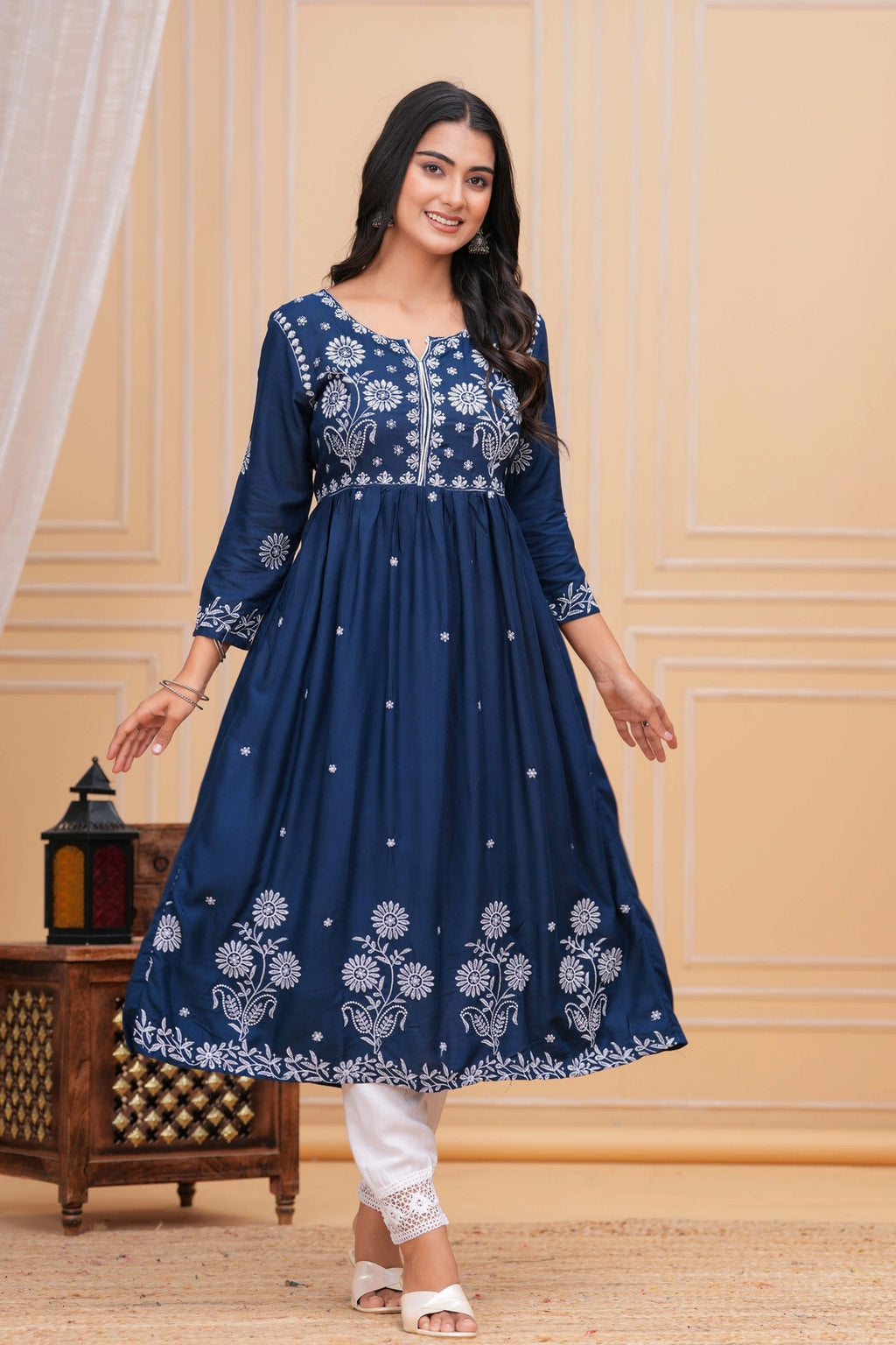 Indigo blue cotton anarkali kurta set with white intricate floral embroidery and white straight pants with lace detail.
