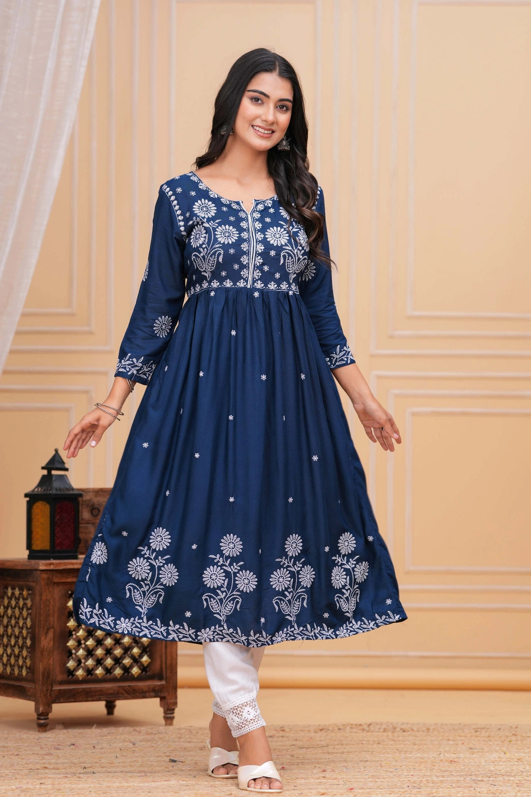 Indigo blue cotton anarkali kurta set with white intricate floral embroidery and white straight pants with lace detail.