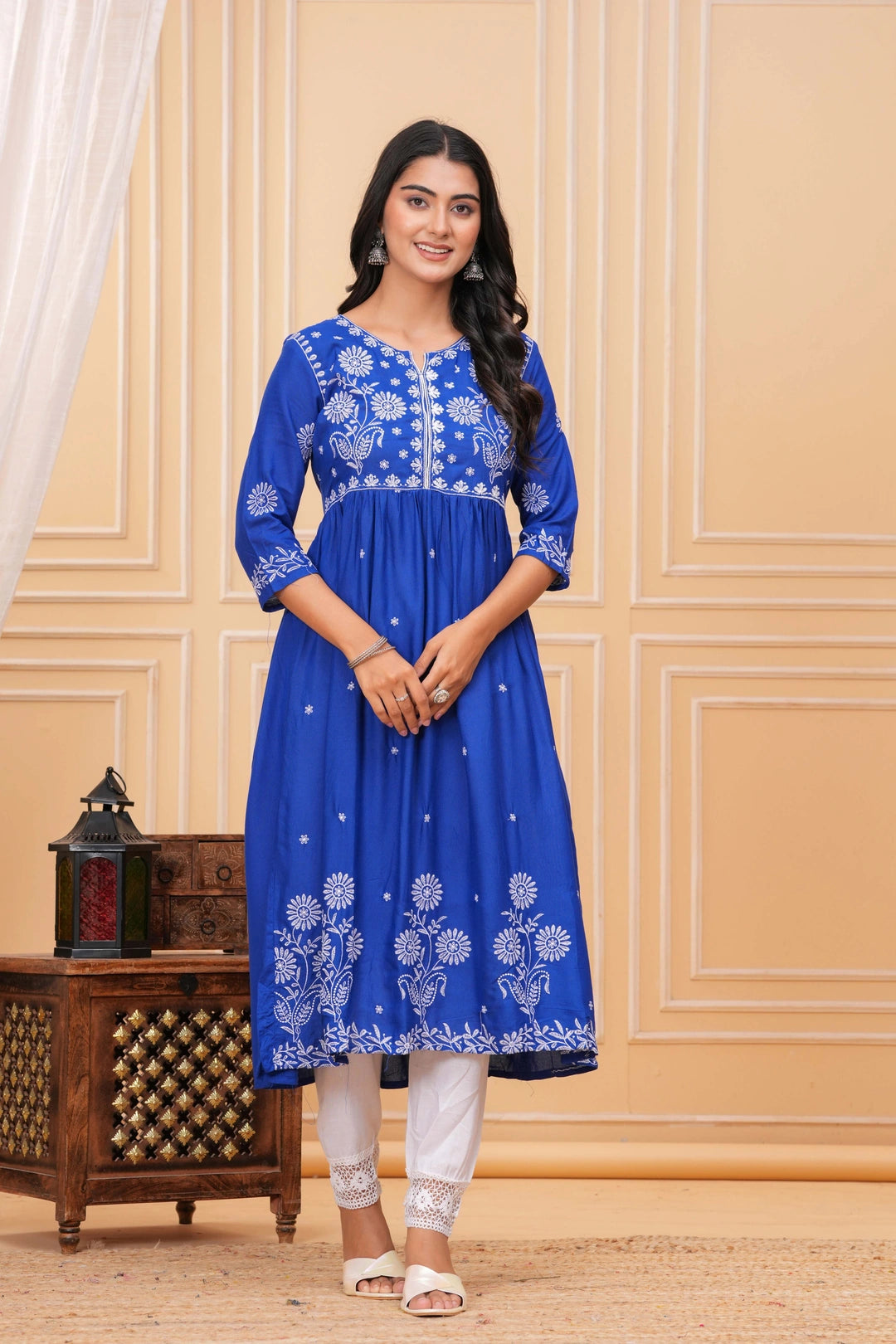 Royal blue cotton suit set with white embroidered floral and peacock motifs, paired with white lace-detailed pants.