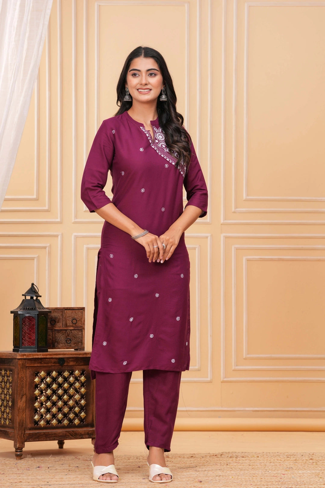 Plum rayon kurta set with white intricate embroidery on the yoke and scattered motif work.