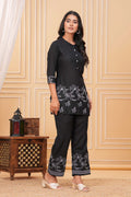 Black cotton suit set with white embroidered tropical palm and deer motifs on the kurta and pants