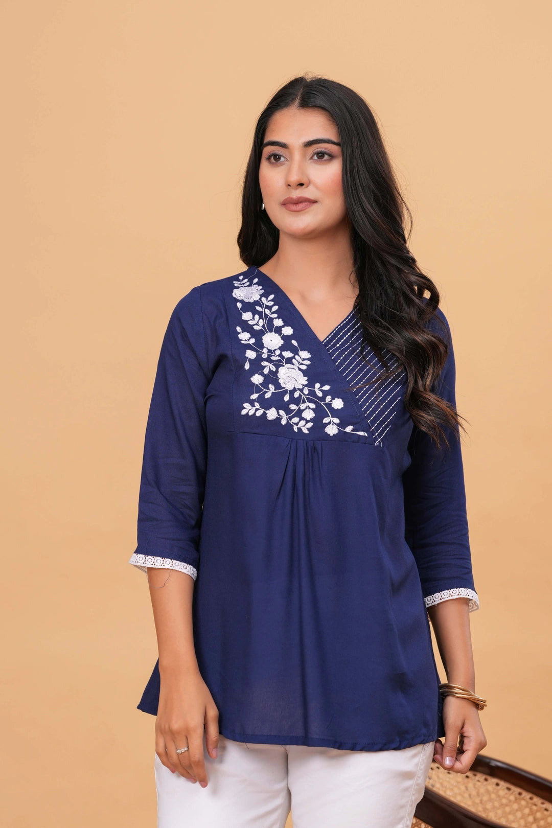 White viscose blend tunic dress with pink and multi-color embroidered geometric patterns and blue tassels