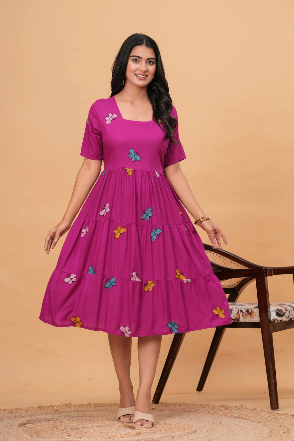 Magenta rayon tiered dress with colorful embroidered butterfly motifs