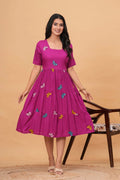 Magenta rayon tiered dress with colorful embroidered butterfly motifs